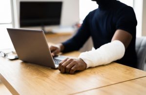 Man with computer and injury